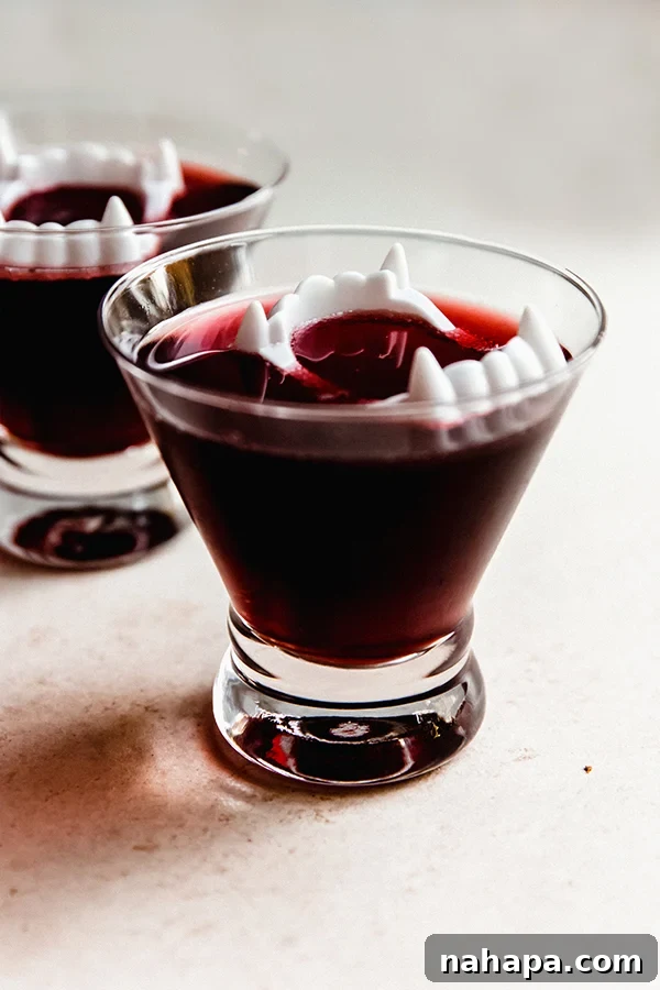 Nightwalker Nectar 3 A glass of Vampire Mocktail, showcasing its vibrant red color and refreshing appearance, ready to be enjoyed.