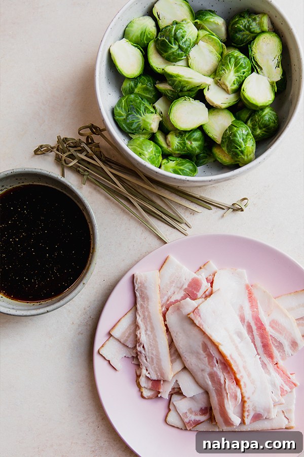 All the fresh ingredients for making bacon wrapped Brussels sprouts laid out on a clean surface.