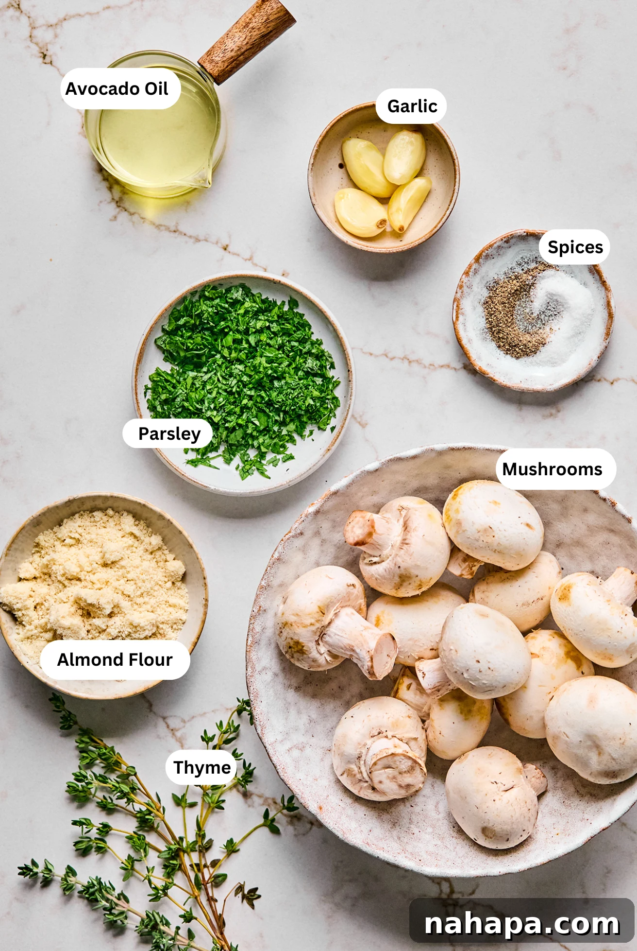 A beautiful flat lay photograph showcasing all the fresh, vibrant ingredients neatly arranged for making gluten and dairy-free stuffed mushrooms.