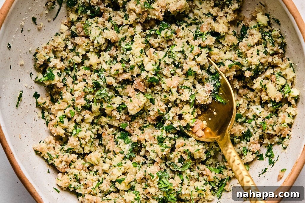 A bowl filled with the savory mushroom and herb mixture, perfectly combined and ready to be spooned into the caps.