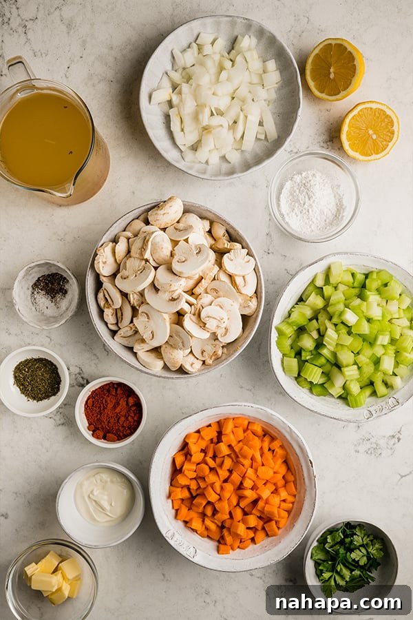 Collection of fresh ingredients for Hungarian mushroom soup displayed in small bowls on a wooden surface.