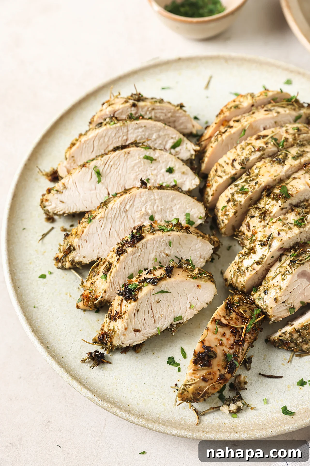 Turkey tenderloin sliced on a plate.
