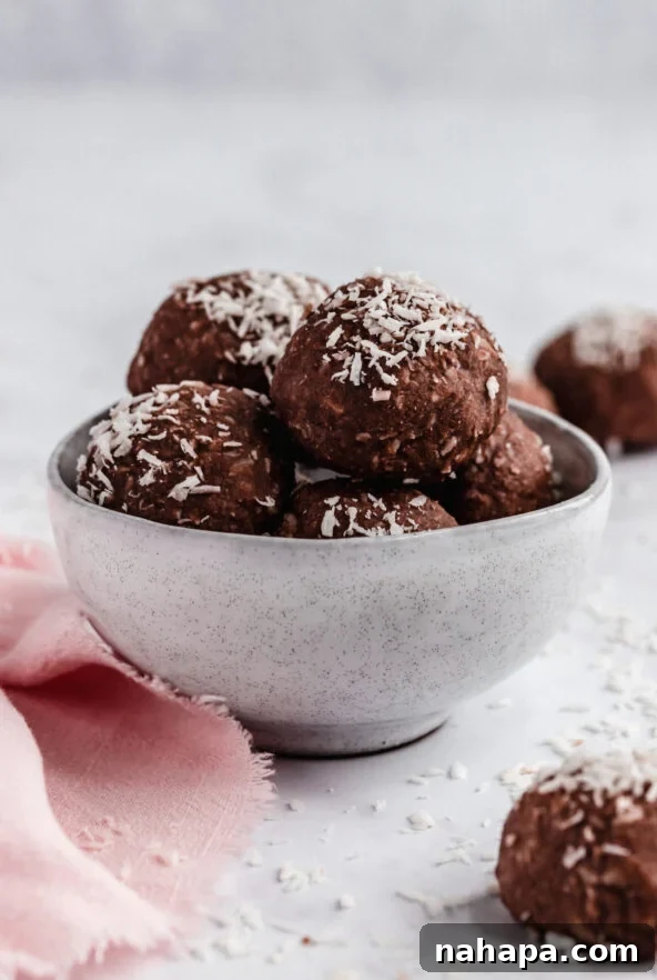 Delicious chocolate collagen protein bites stacked on a plate.