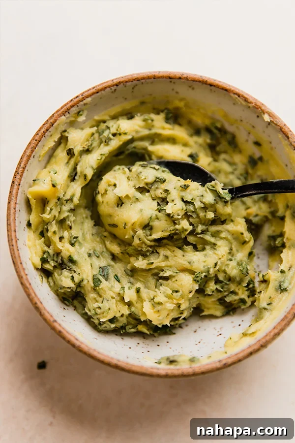 A bowl of freshly prepared aromatic herb butter, ready to be applied to the turkey.
