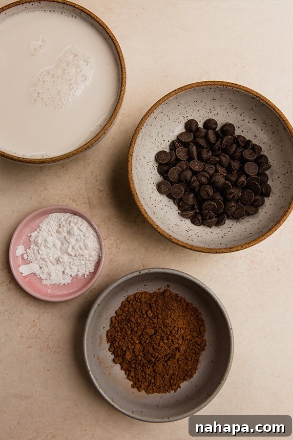 A close-up of melted chocolate and cocoa powder being stirred into warm almond milk in a saucepan.
