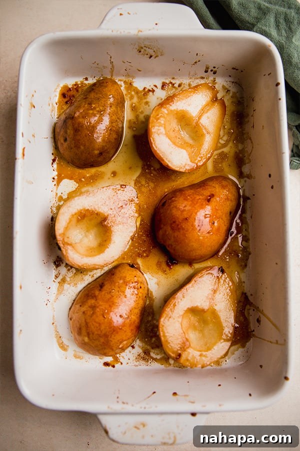 Perfectly Simple Baked Pears 4 Close up of a single perfectly baked pear half, showing its tender flesh and golden caramelization.