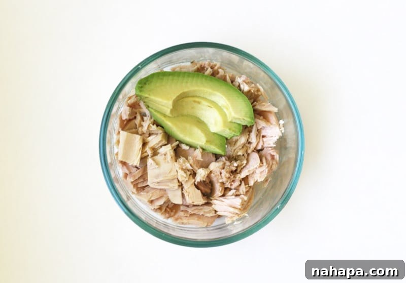 Quick and Wholesome Paleo AIP Snacks for Life on the Go 4 A scoop of wild-caught tuna mixed with avocado, in a small bowl.