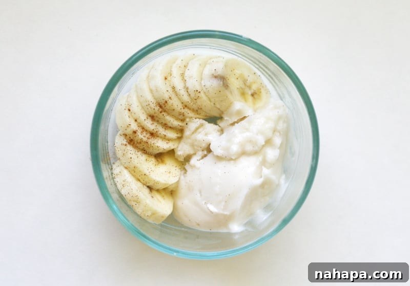 Quick and Wholesome Paleo AIP Snacks for Life on the Go 6 Sliced banana pieces topped with a dollop of coconut butter and a sprinkle of cinnamon.