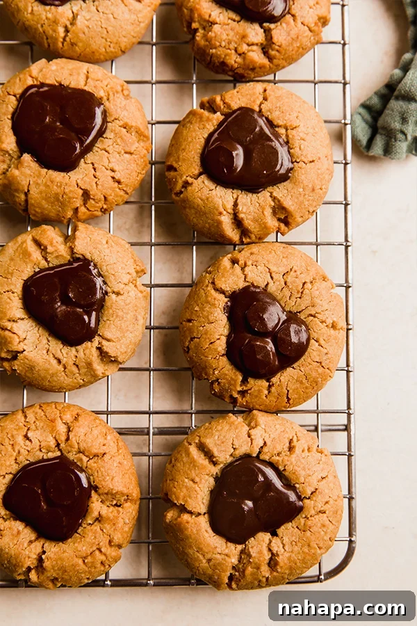 Guilt-Free Paleo Vegan Almond Butter Blossoms 5 Freshly baked almond butter blossoms cooling on a wire rack.