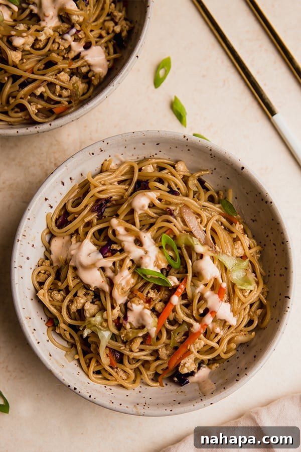 A single serving of egg roll ramen stir fry in a bowl, showcasing its vibrant ingredients and inviting aroma.