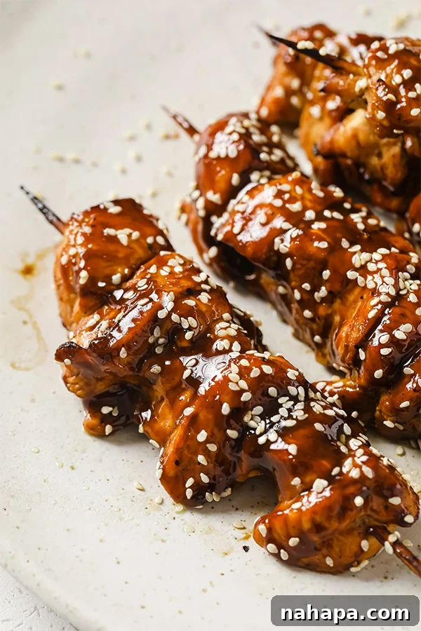 Sticky Teriyaki Chicken Skewers with Slaw 5 A plate featuring perfectly cooked teriyaki chicken skewers, ready to be served.