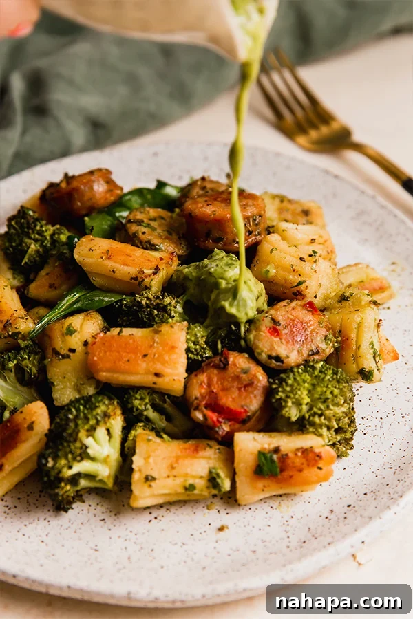 Roasted Gnocchi and Sausage Sheet Pan Dinner Gluten-Free 4 A plate with gnocchi & sausage sheet pan dinner, garnished with fresh herbs.