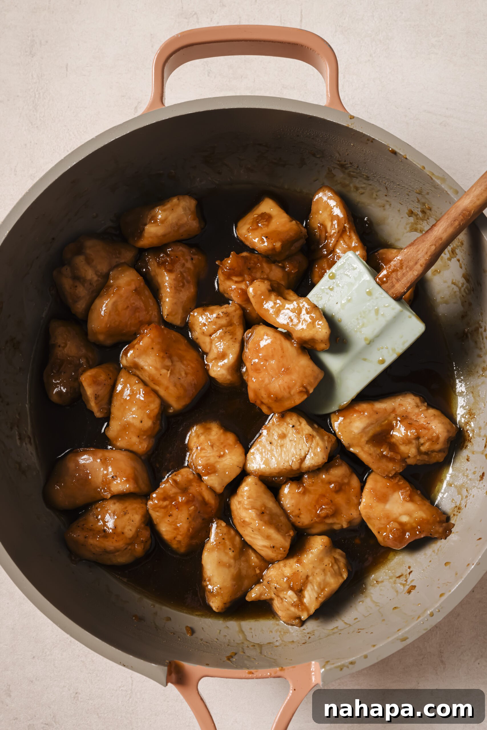 Cooked chicken, cubed in a pan tossed with a honey butter sauce.
