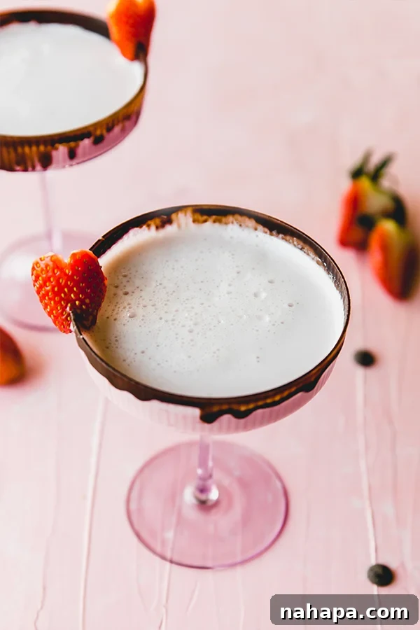 A beautifully presented chocolate covered strawberry mocktail, ready to be enjoyed on a cozy table setting.