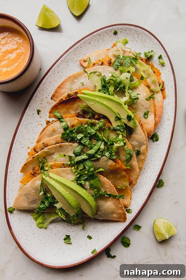 Crispy Baked Ground Beef Tacos Dairy-Free 2 A vibrant serving platter of golden-brown baked ground beef tacos, featuring crispy edges and a delicious filling.