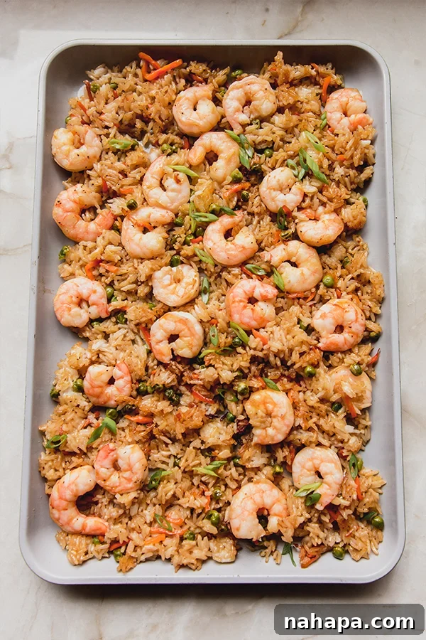 A pan of sheet pan shrimp fried rice after cooking.