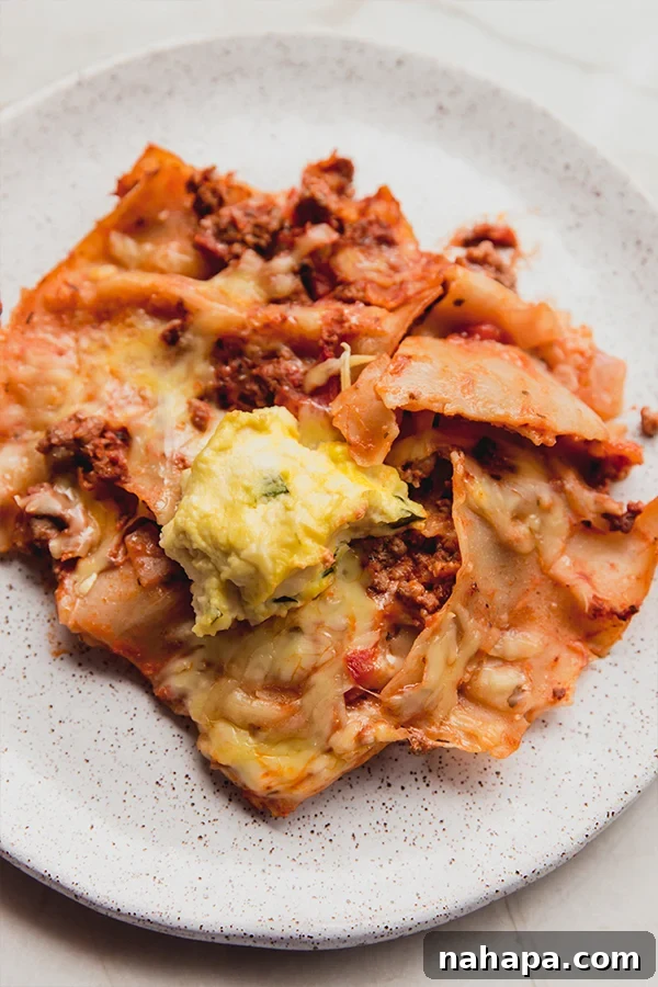 A plate full of gluten-free sheet pan lasagna, garnished with fresh herbs, ready to be enjoyed.