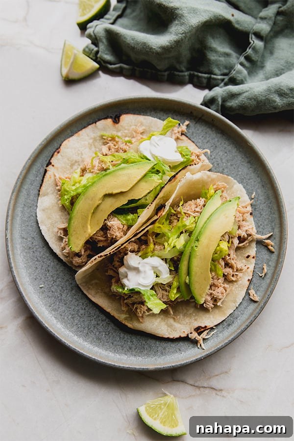 A beautifully plated slow cooker ranch chicken taco, showcasing the tender chicken and fresh toppings.