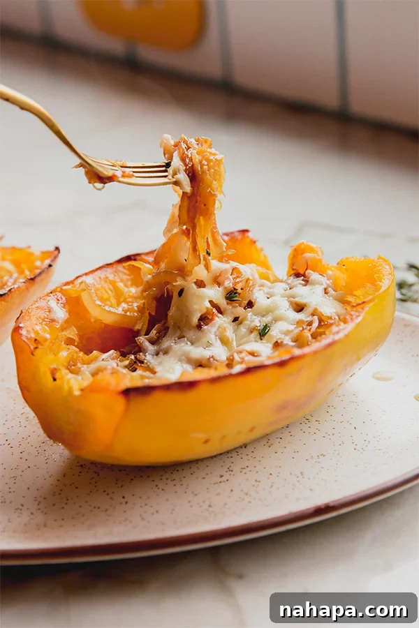 A French onion spaghetti squash boat with a fork in it, showing the creamy, cheesy filling.