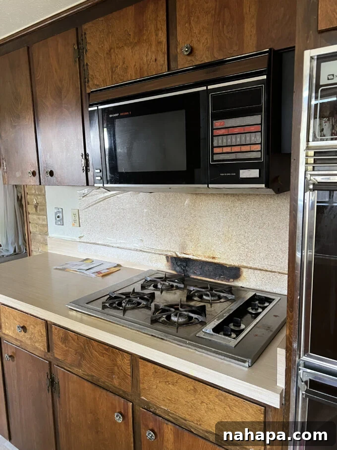 Before kitchen renovation - burnt peel and stick backsplash