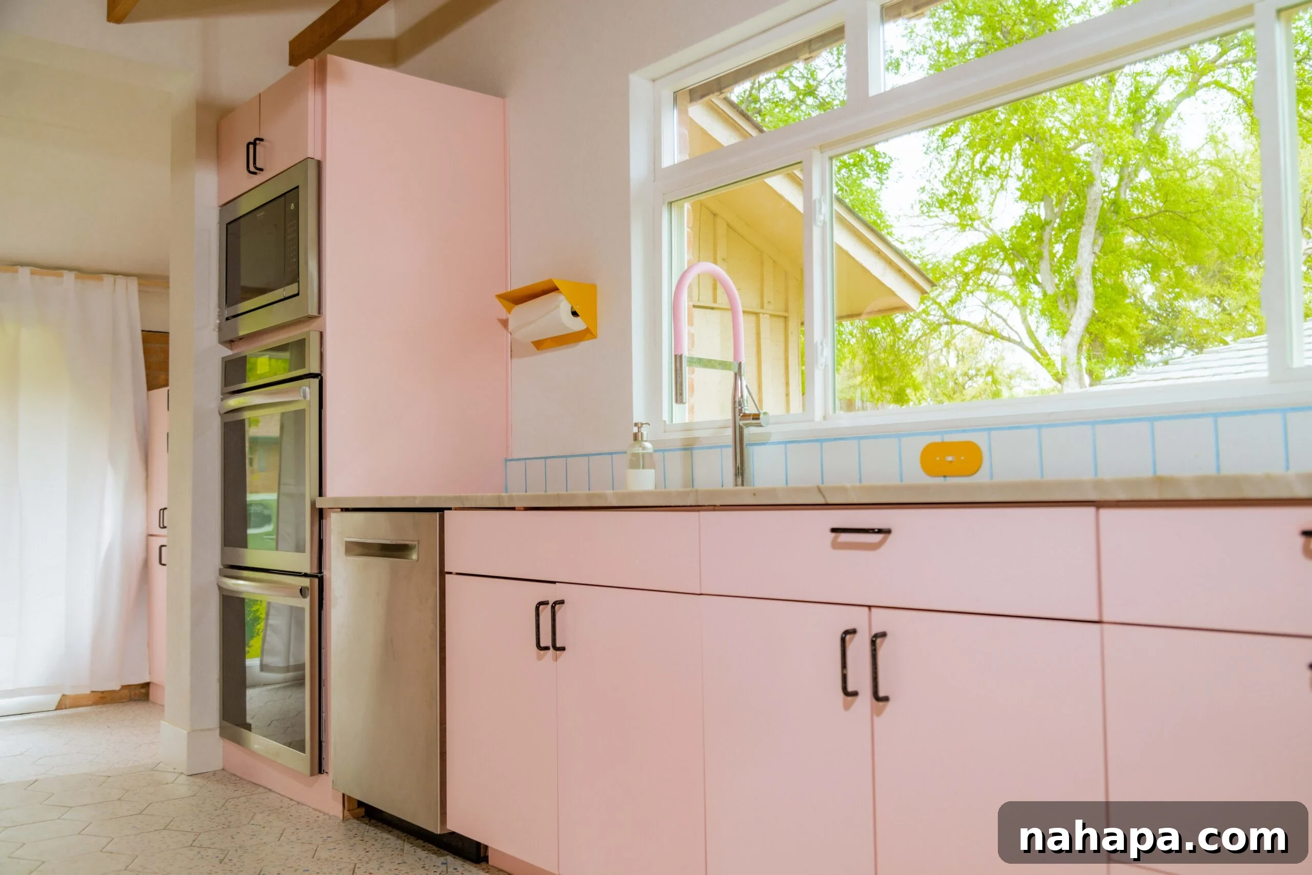 After kitchen renovation - pink cabinets and modern appliances
