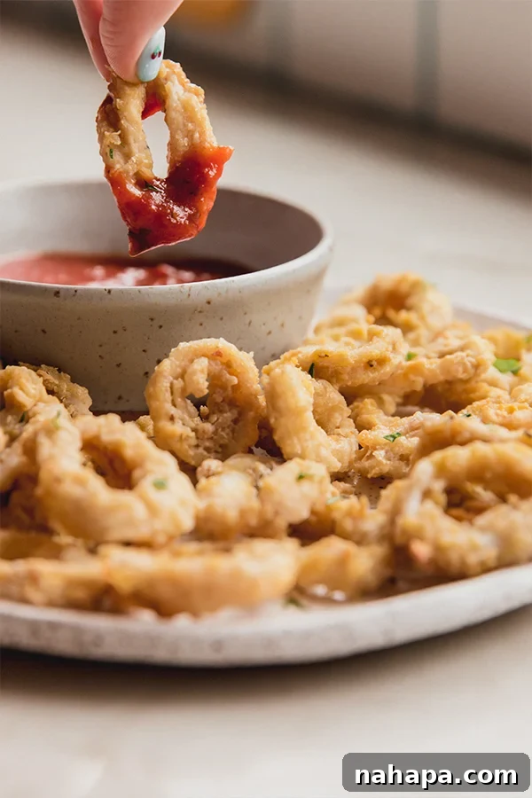 Air Fryer Golden Crispy Gluten Free Calamari 5 A plate of calamari after cooking and dipping into sauce.