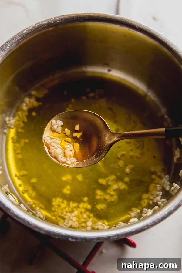 Artisanal Gluten Free Italian Grissini 4 A small bowl filled with garlic-infused melted ghee, ready to be brushed on breadsticks.