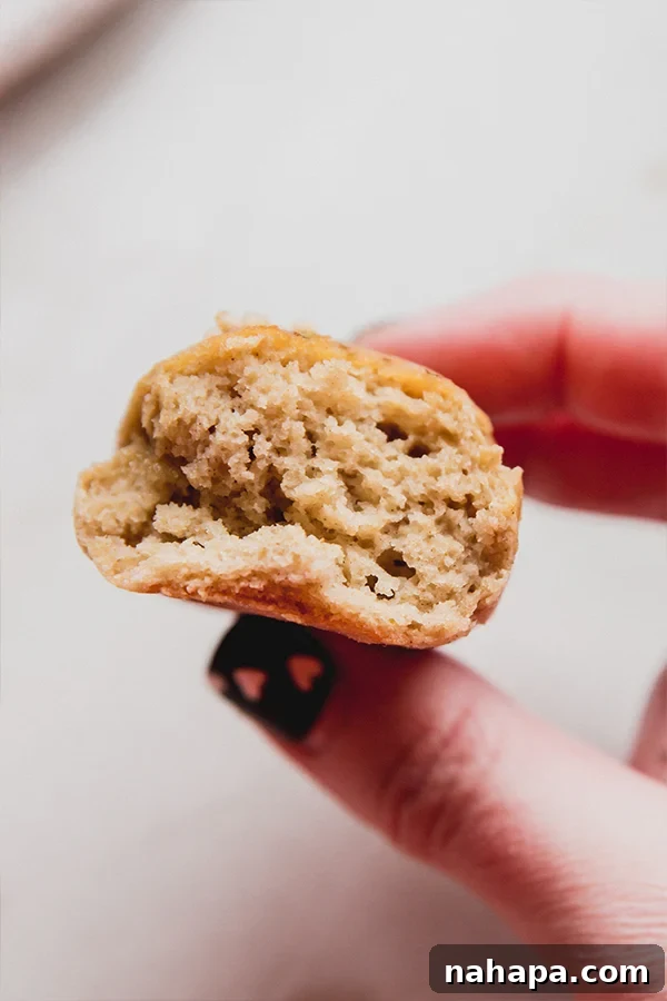 Artisanal Gluten Free Italian Grissini 5 A gluten-free breadstick being held in a hand, showing a bite taken from one end.