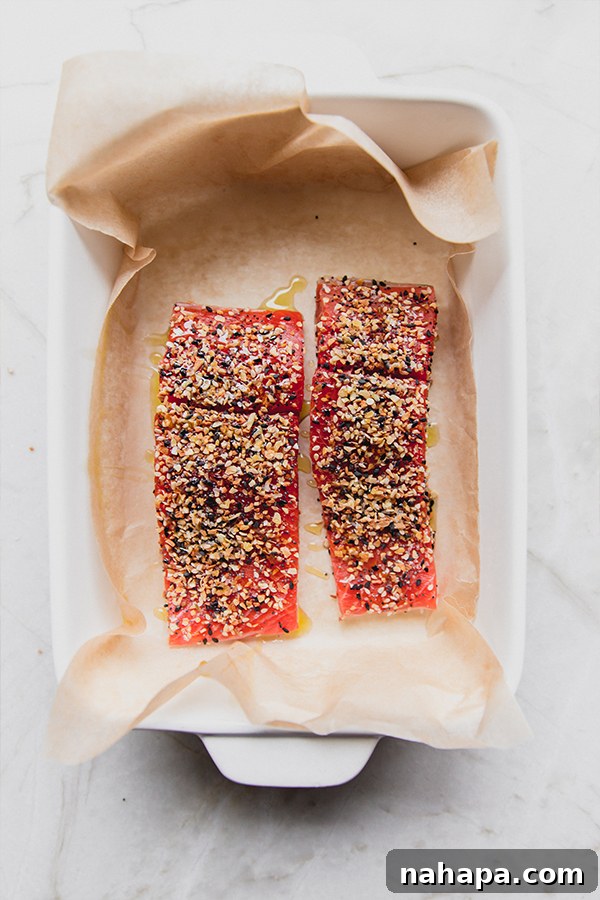 Everything Bagel Salmon Delight 4 Two salmon filets generously coated with everything bagel seasoning, placed in a baking dish, ready to be cooked.