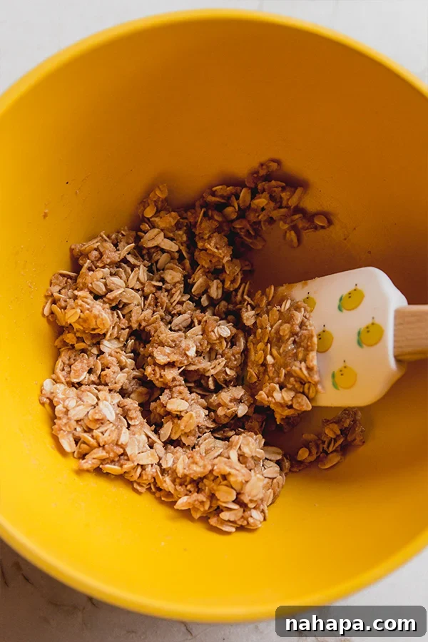 A bowl with the crumble topping mixture ready to be spread on peaches.