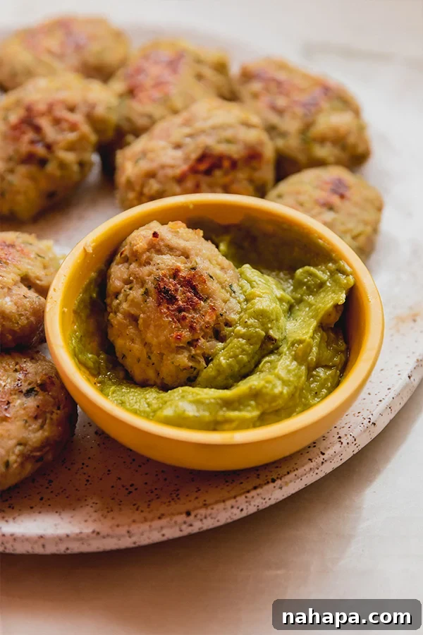 A vibrant plate featuring golden zucchini chicken nuggets alongside various delicious dipping sauces.