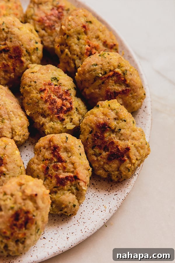 Close-up of freshly baked zucchini chicken nuggets artfully arranged, promising a delightful and healthy meal.