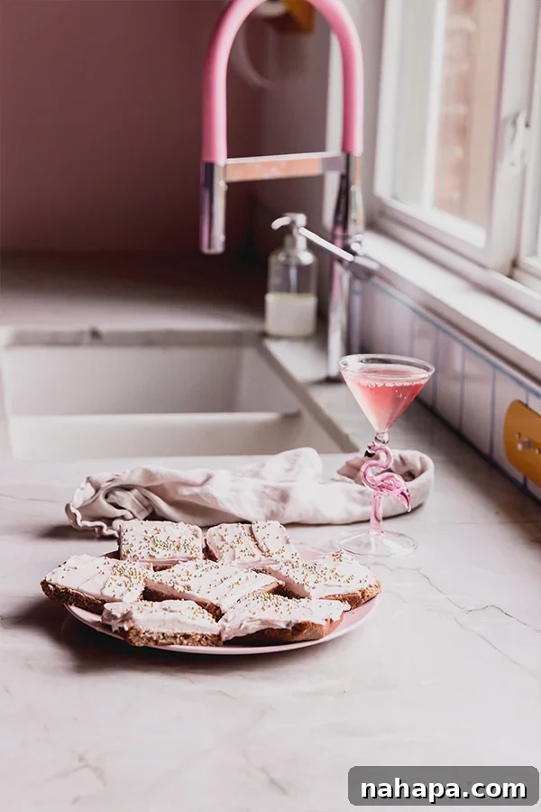 A plate of funfetti pink sugar cookie bars on the counter.
