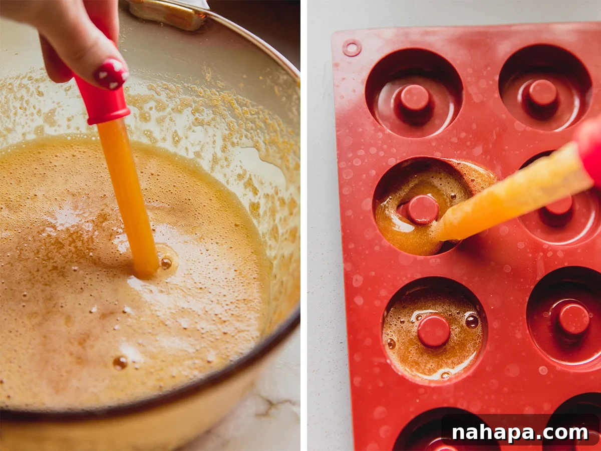 The peach ring gummy liquid being carefully added to the molds before the setting process begins.