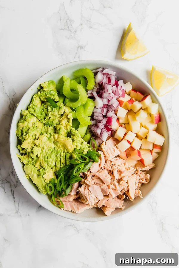 15 Simple Gluten and Dairy Free Lunch Solutions 14 A bowl of creamy avocado tuna salad, garnished with fresh herbs, ready to be enjoyed.
