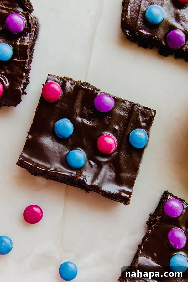 Fudgy almond flour space brownies topped with colorful Unreal Crispy Quinoa Gems