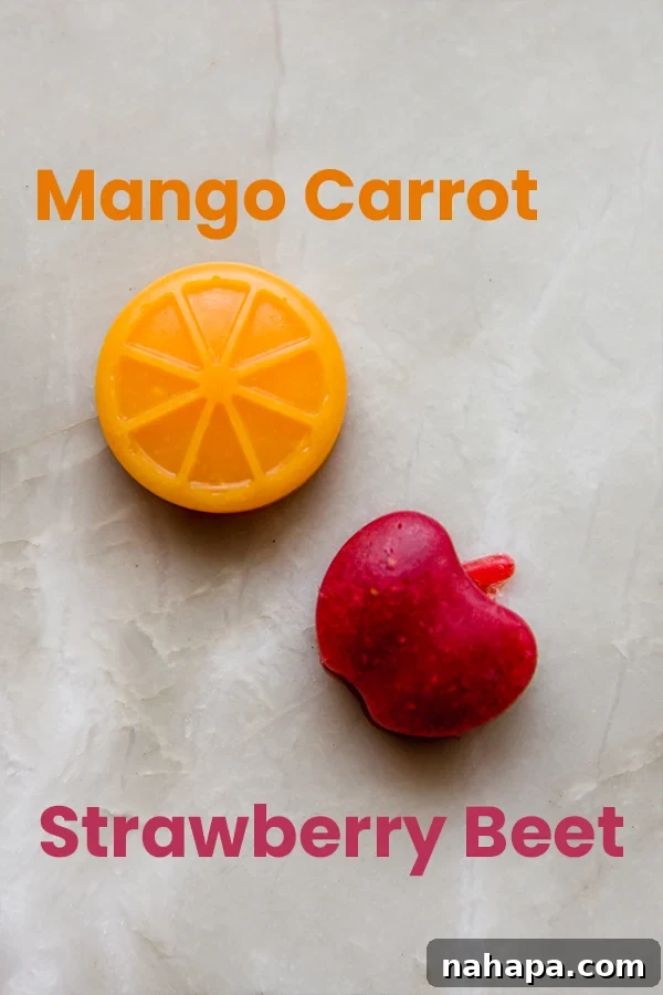 A close-up shot of two homemade fruit snacks, one mango-carrot and one strawberry-beet, showing their distinct vibrant colors.