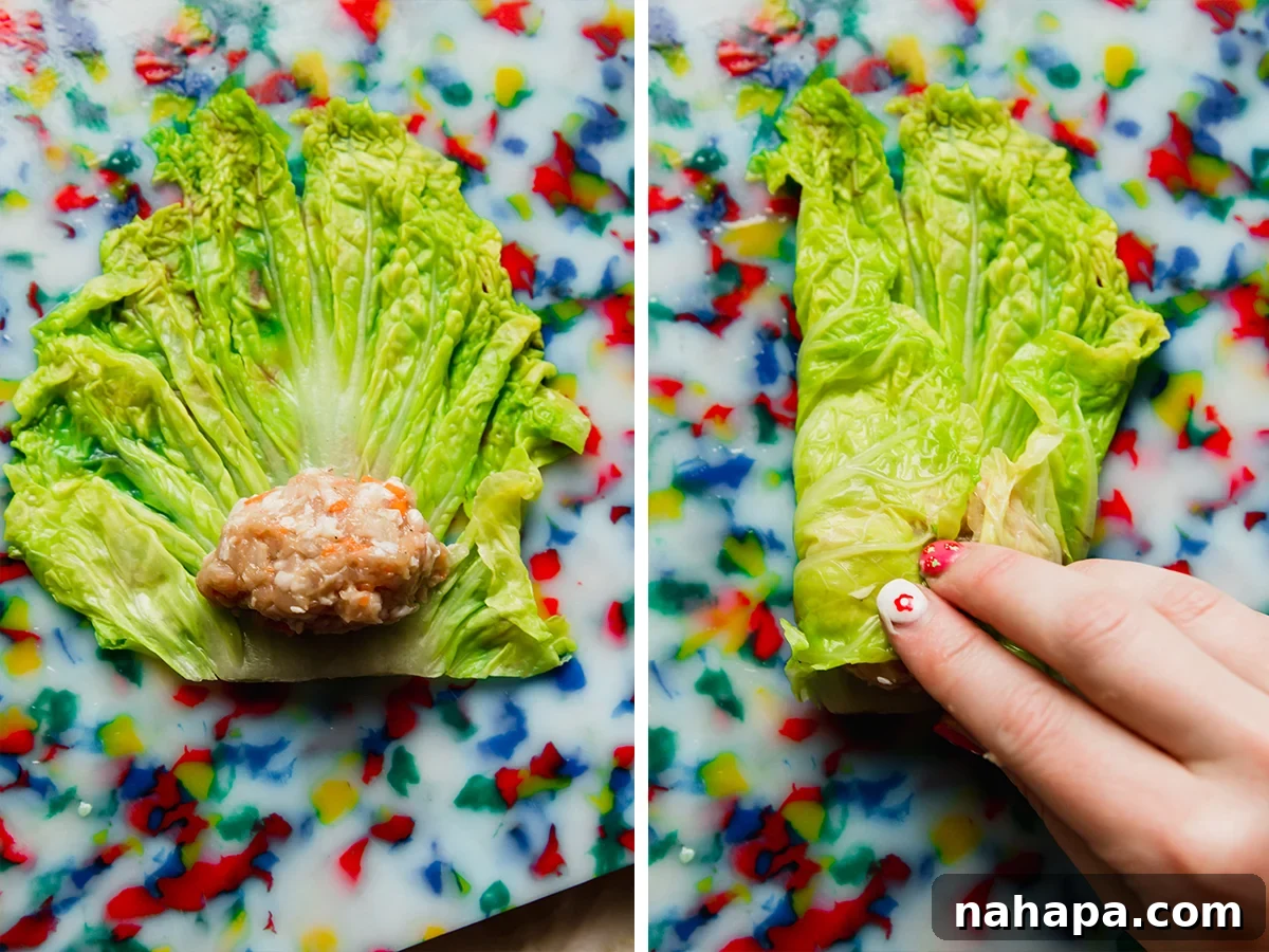 Demonstration of forming a cabbage roll dumpling: placing the chicken filling onto a blanched cabbage leaf, then folding and rolling it tightly.