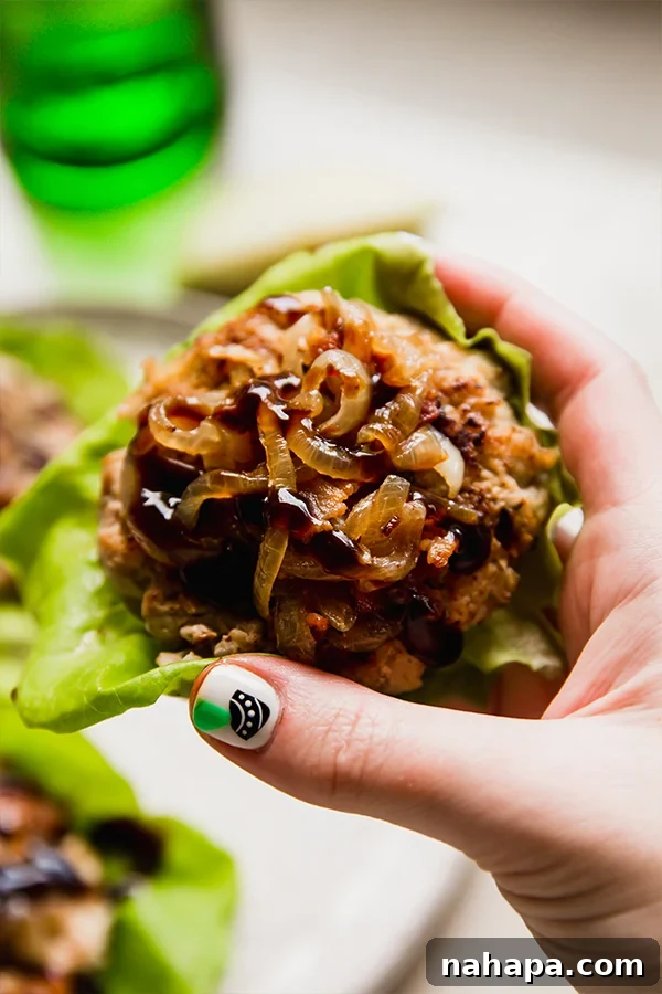 Apple Chicken Burgers, a perfect fall dish, topped with bacon caramelized onions and balsamic glaze.