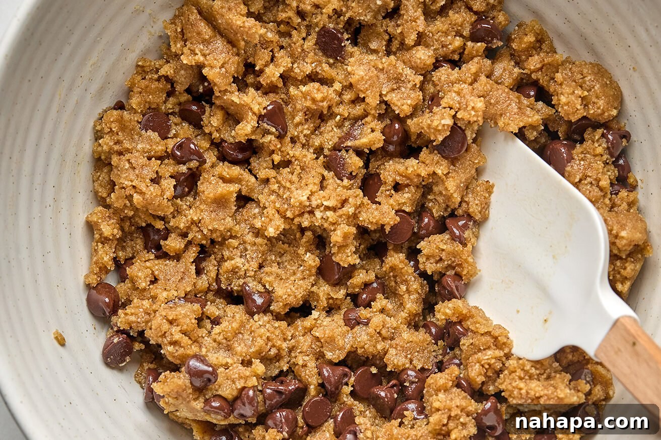 Spiced Gluten Free Pumpkin Chocolate Chip Cookie Bars 5 The cookie bar ingredients in a bowl, perfectly mixed together with dairy-free chocolate chips folded throughout the dough.