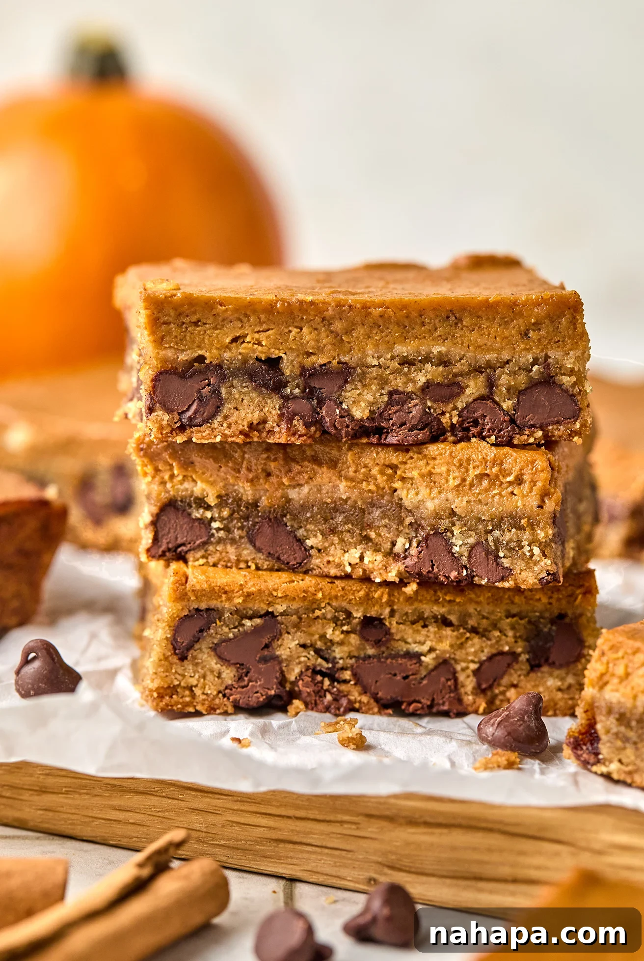 Spiced Gluten Free Pumpkin Chocolate Chip Cookie Bars 10 Three perfectly stacked pumpkin chocolate chip cookie bars, showcasing their irresistible layers and deliciousness.