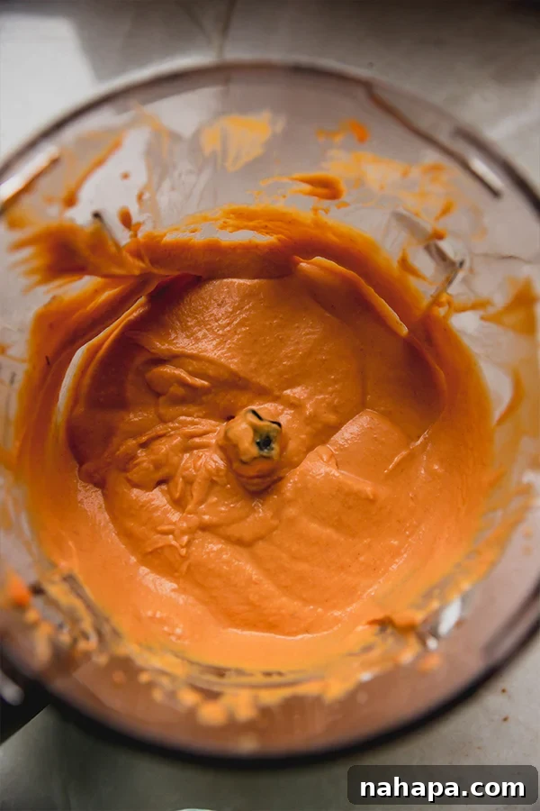 Velvety Plant-Based Pumpkin Treat Cups 3 A blender filled with creamy pumpkin filling after blending.