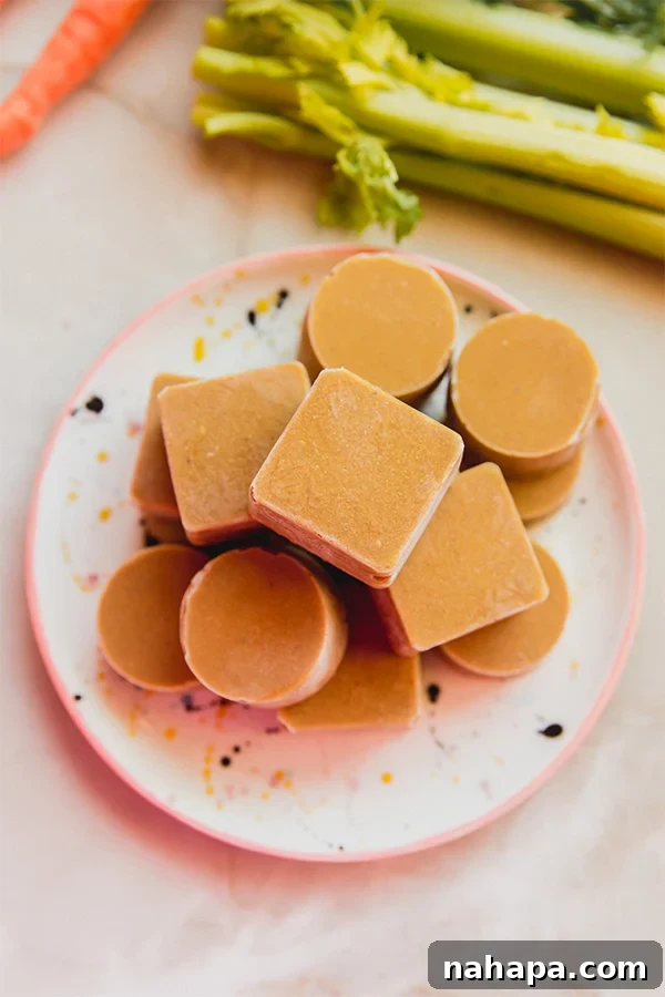 A stack of golden-brown homemade beef bouillon cubes neatly arranged, showcasing their concentrated form.