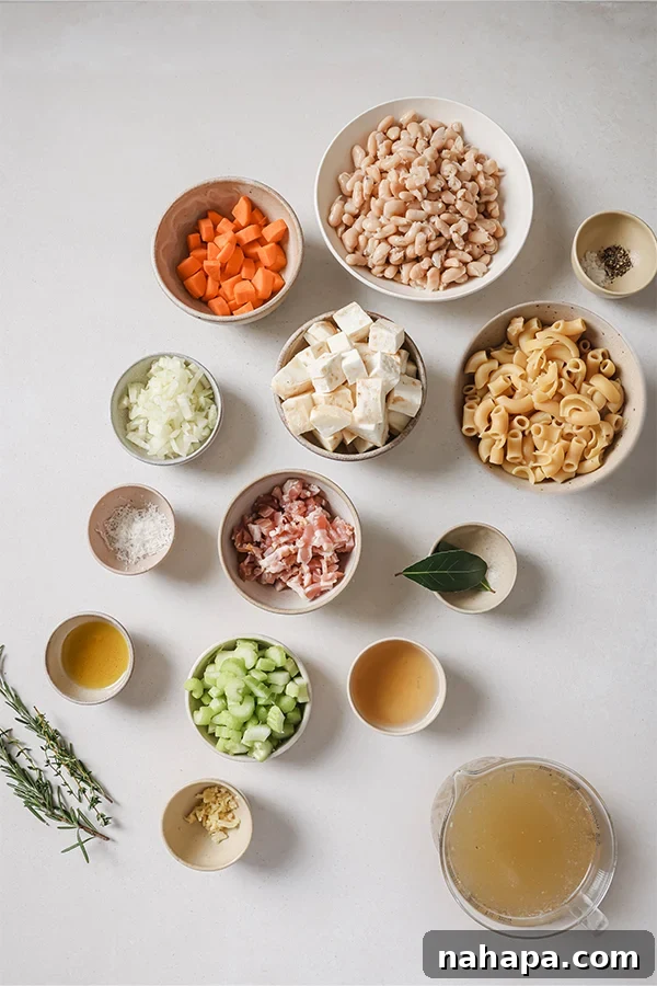 All the wholesome ingredients neatly arranged on a cutting board, ready for making white pasta fagioli soup.
