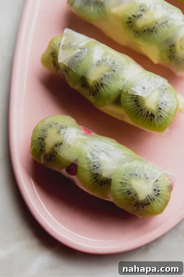 Winter Fruit Fresh Rolls 2 A plate with beautifully arranged winter fruit rice paper rolls, showcasing the colorful fruits inside.