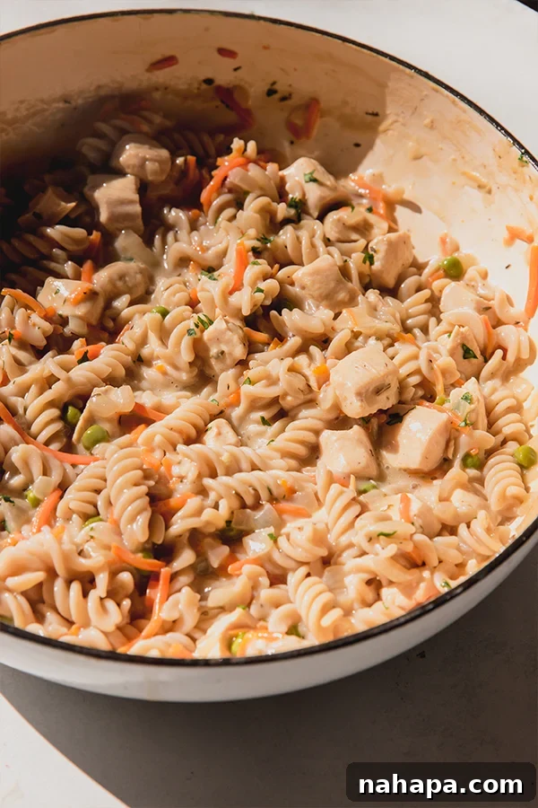 A pot of creamy chicken pot pie pasta, freshly cooked and ready to be served.