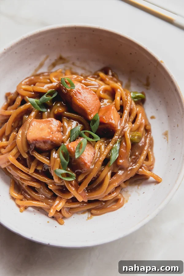 Sticky Honey Garlic Chicken Noodle Bake Gluten Free 4 A bowl with a serving of baked honey garlic chicken noodle dish ready to be eaten, showing the rich sauce and tender chicken.