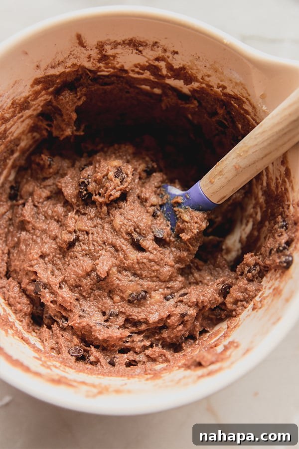 Irresistible Gluten-Free Chocolate Banana Muffins 3 Close-up of a bowl of chocolate banana bread muffin batter, ready for baking.