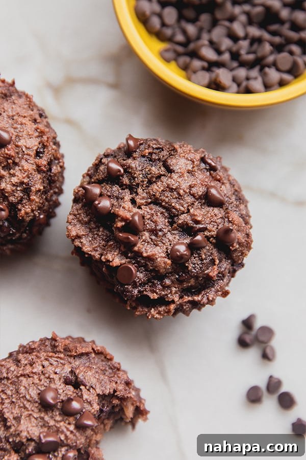 Irresistible Gluten-Free Chocolate Banana Muffins 5 Delicious gluten-free chocolate banana bread muffins cooling on a wire rack on a kitchen counter.