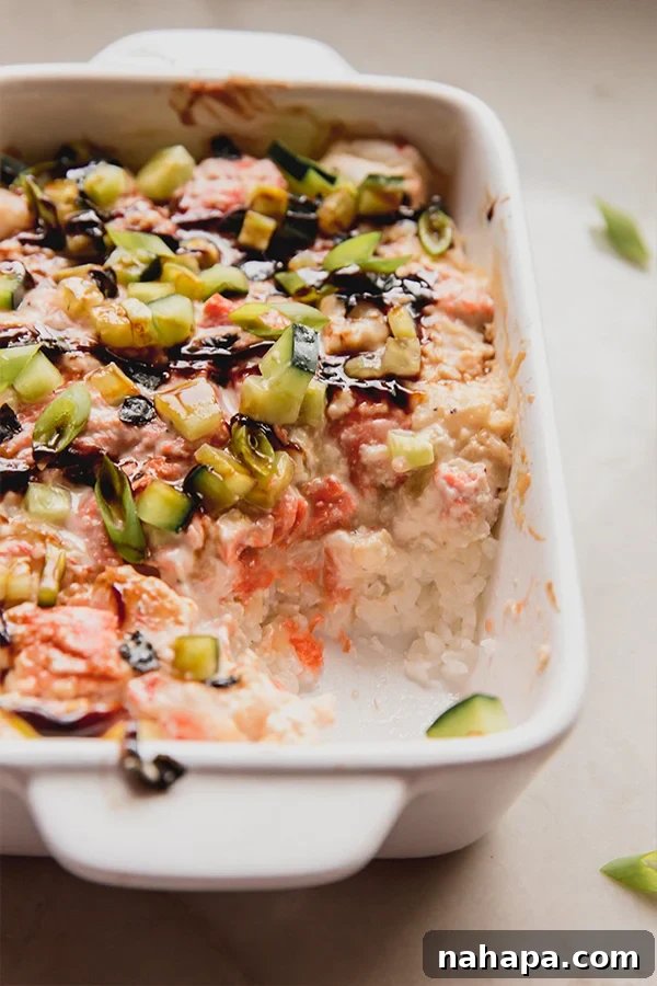 A mini sushi bake with a scoop taken out of it.